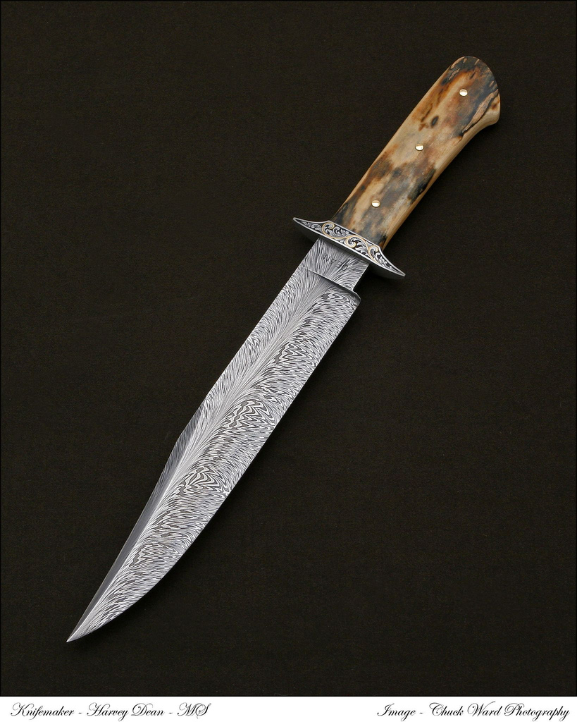 *SOLD* HARVEY DEAN - EL DIABLO FIGHTER - PREMIUM MAMMOTH IVORY HANDLE WITH SCROLL ENGRAVING AND 24K GOLD INLAY BY JERE DAVIDSON ON ON THE STAINLESS DOUBLE GUARD AND THREE 18K GOLD PINS. 9" 1084 AND 15N20 FEATHER PATTERN DAMASCUS BLADE. THIS FIGHTER IS EXTREMELY QUICK AND LIGHT. DEPICTED PG. 157 "KNIVES 2009". CUSTOM TOOL LEATHER SHEATH BY PAUL LONG. BOUGHT FROM HARVEY @ '07 FISK INVENTATIONAL SHOW.